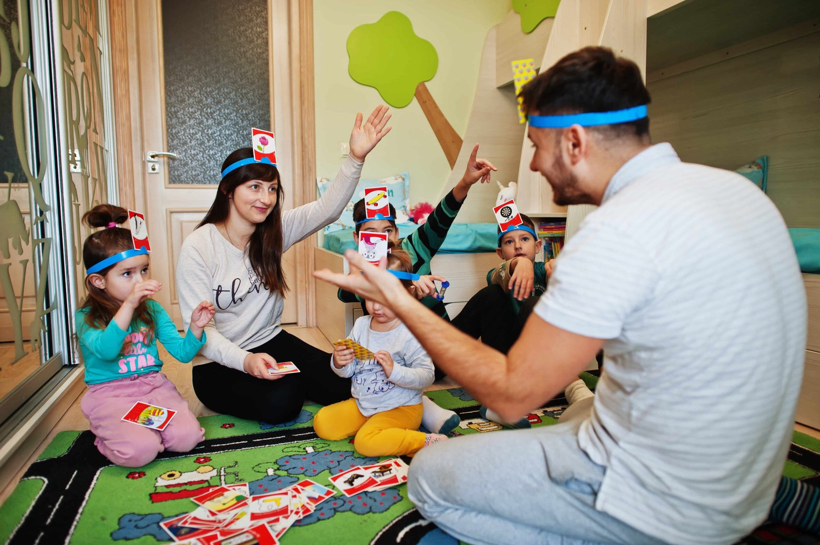 happy-family-with-four-kids-playing-game-guess-who-2023-11-27-05-13-01-utc